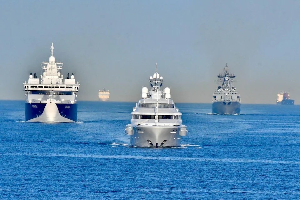 The superyacht Graceful accompanied by a Russian destroyer (right) and a rescue and patrol vessel