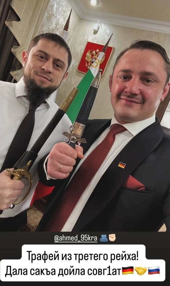 Noah Krieger presenting Chechnya's deputy prime minister Akhmed Dudaev with a Nazi-era Luftwaffe dagger bearing a swastika